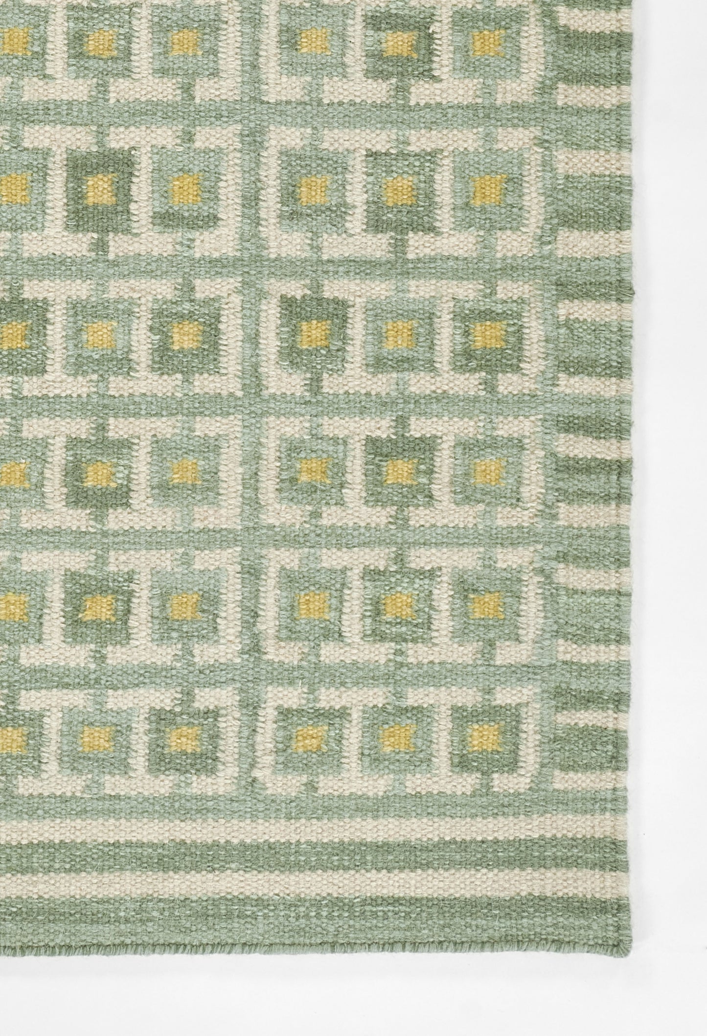 Scandinavian-style woven scarf in green-grey grid with pale yellow centers and a bordered edge.