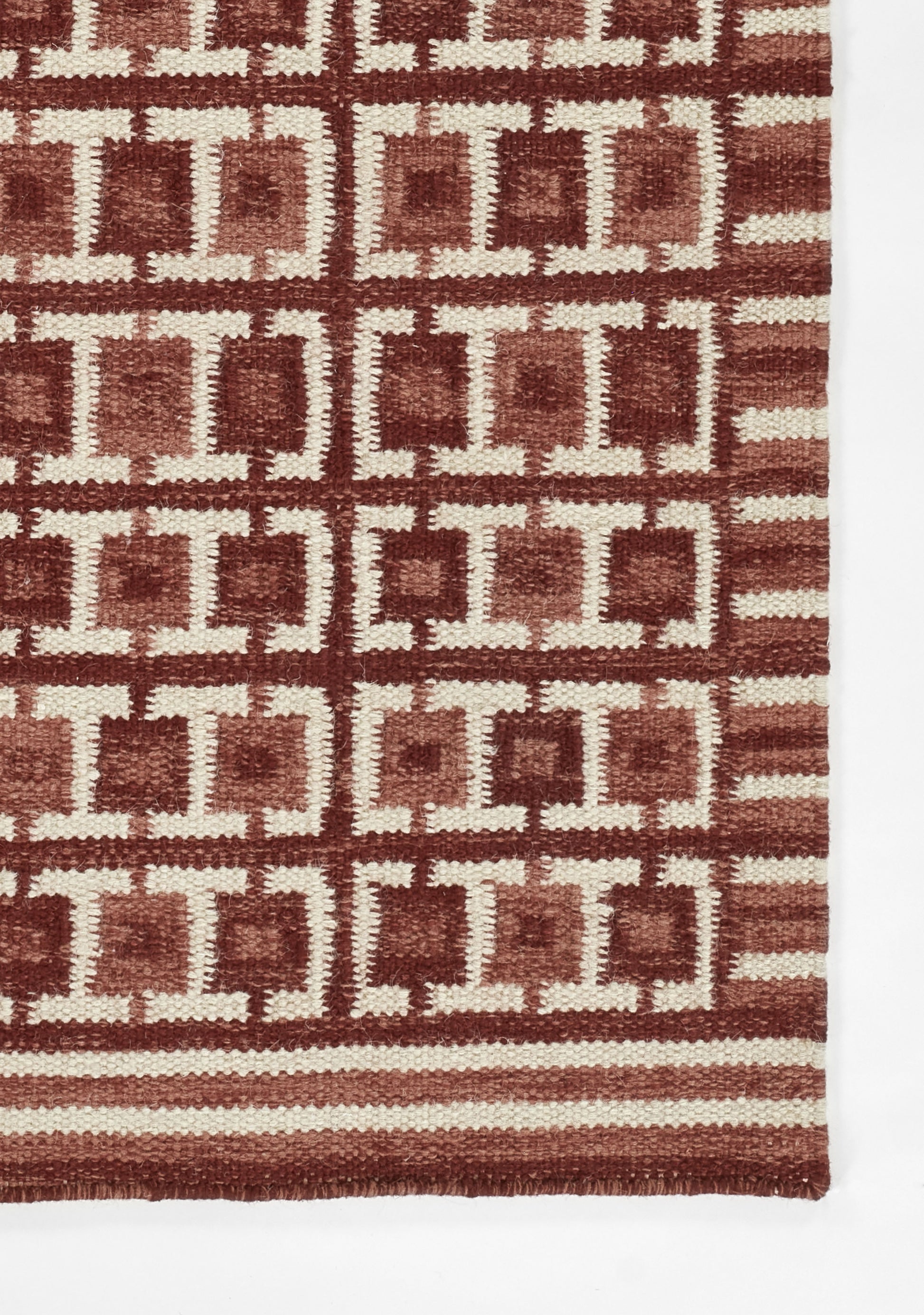Rectangular red and cream woven rug in Scandinavian style with a cream square lattice pattern and striped border, 8' x 10'.