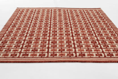 Red and ivory geometric woven area rug with repeating square motif.