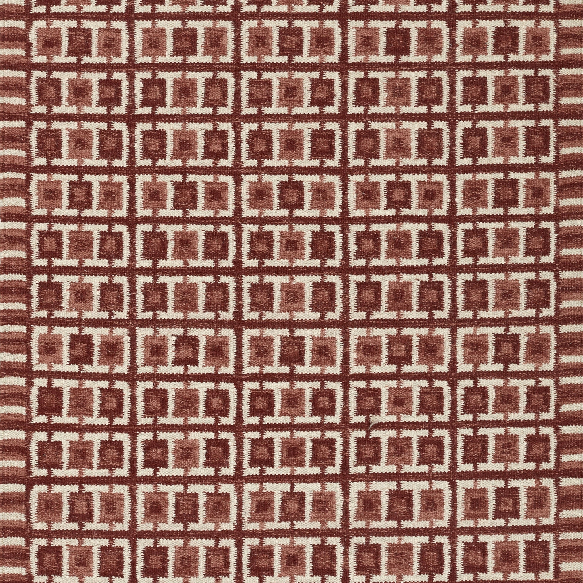 Red fabric with cream interlocking square grid pattern; Scandinavian-inspired geometric textile.