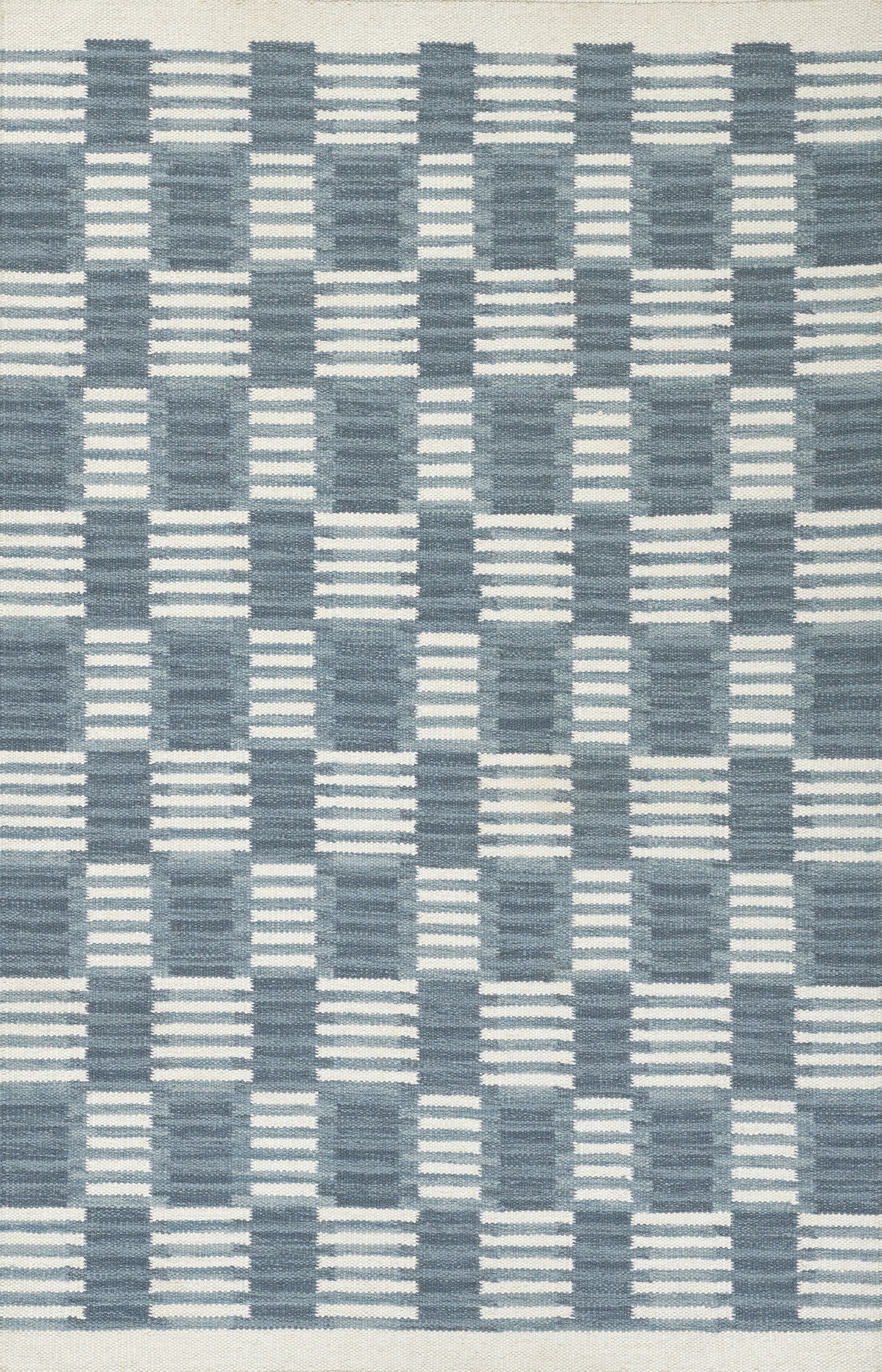 Scandinavian-inspired blue woven rug with navy and light-blue checker/grid pattern, geometric floor decor.