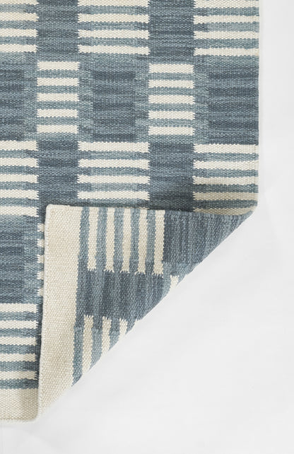 Blue and ivory woven rug with a geometric grid pattern; Scandinavian style floor decor.