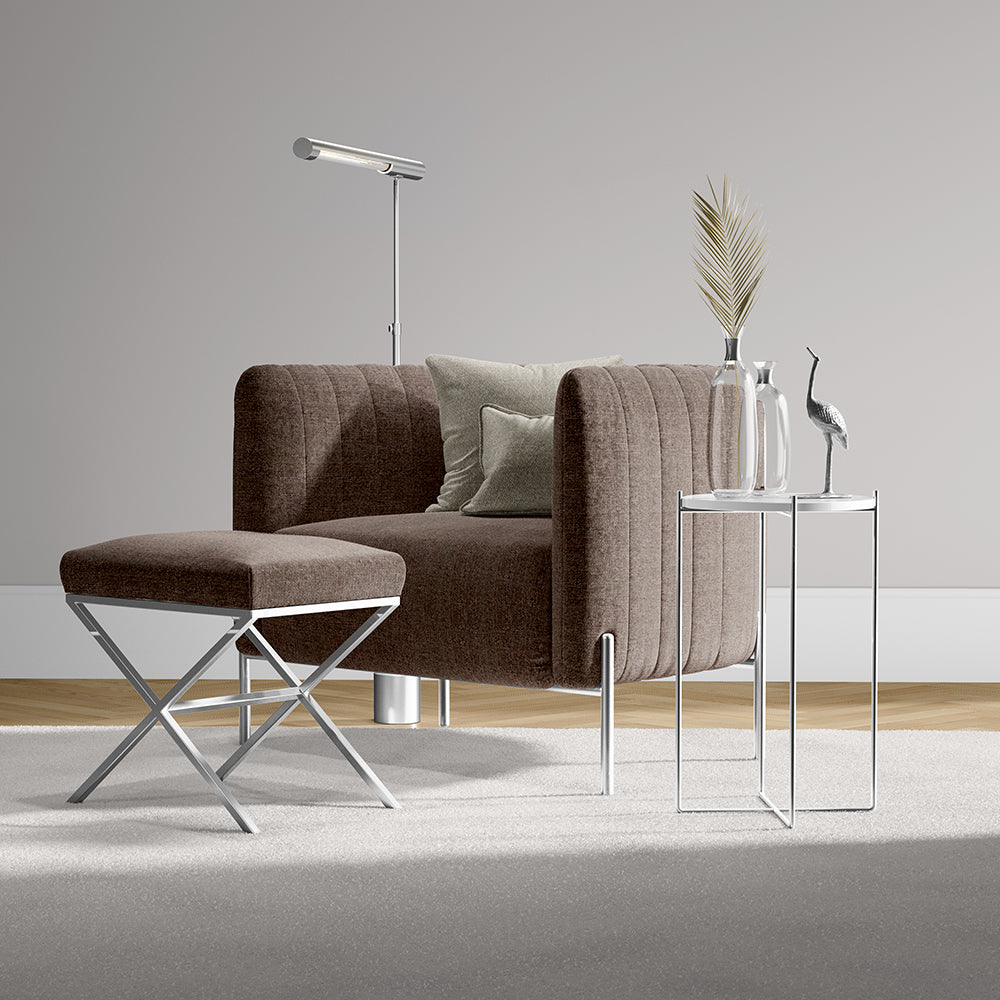 Mulberry solid fabric upholstery on a brown sofa in a contemporary living space with ottoman, chrome floor lamp, glass-and-metal side tables, and a vase with pampas grass.