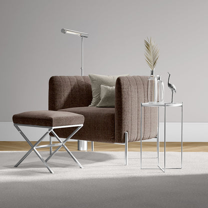 Mulberry solid fabric upholstery on a brown sofa in a contemporary living space with ottoman, chrome floor lamp, glass-and-metal side tables, and a vase with pampas grass.