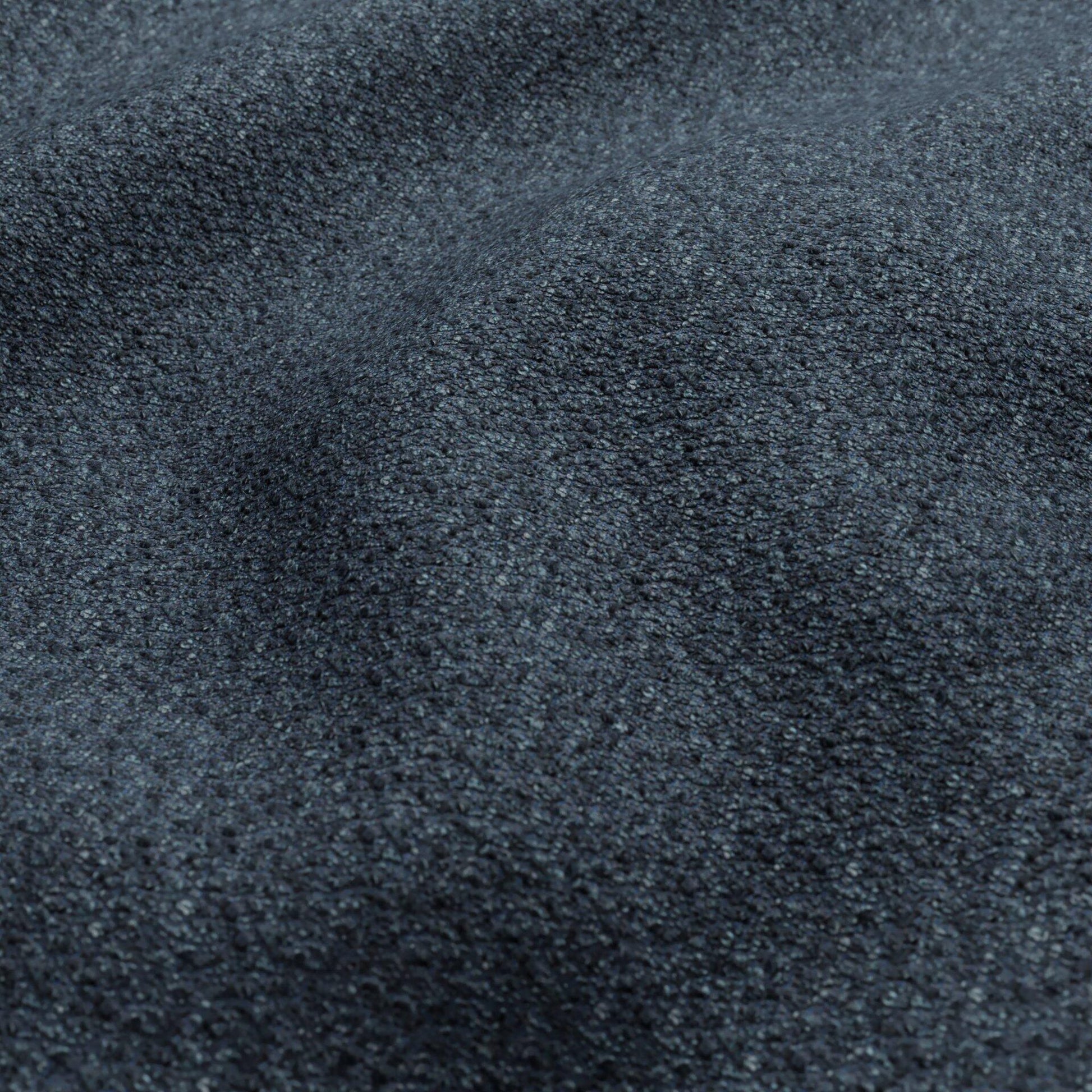 Dark blue and teal boucle fabric close-up with a textured surface.