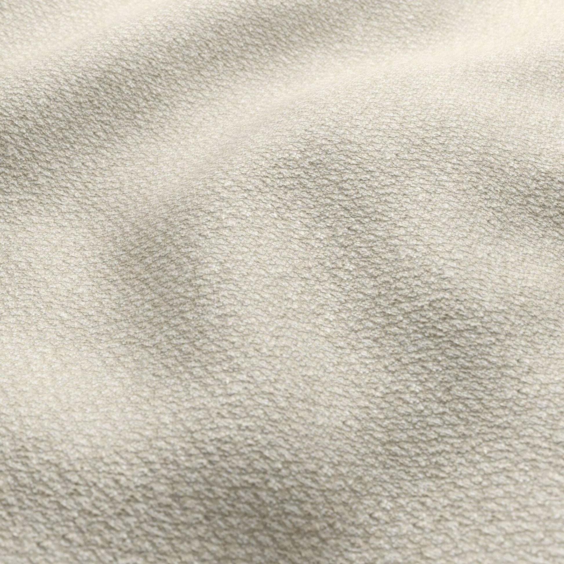 Beige and cream boucle fabric close-up with a textured, nubby surface and soft folds.