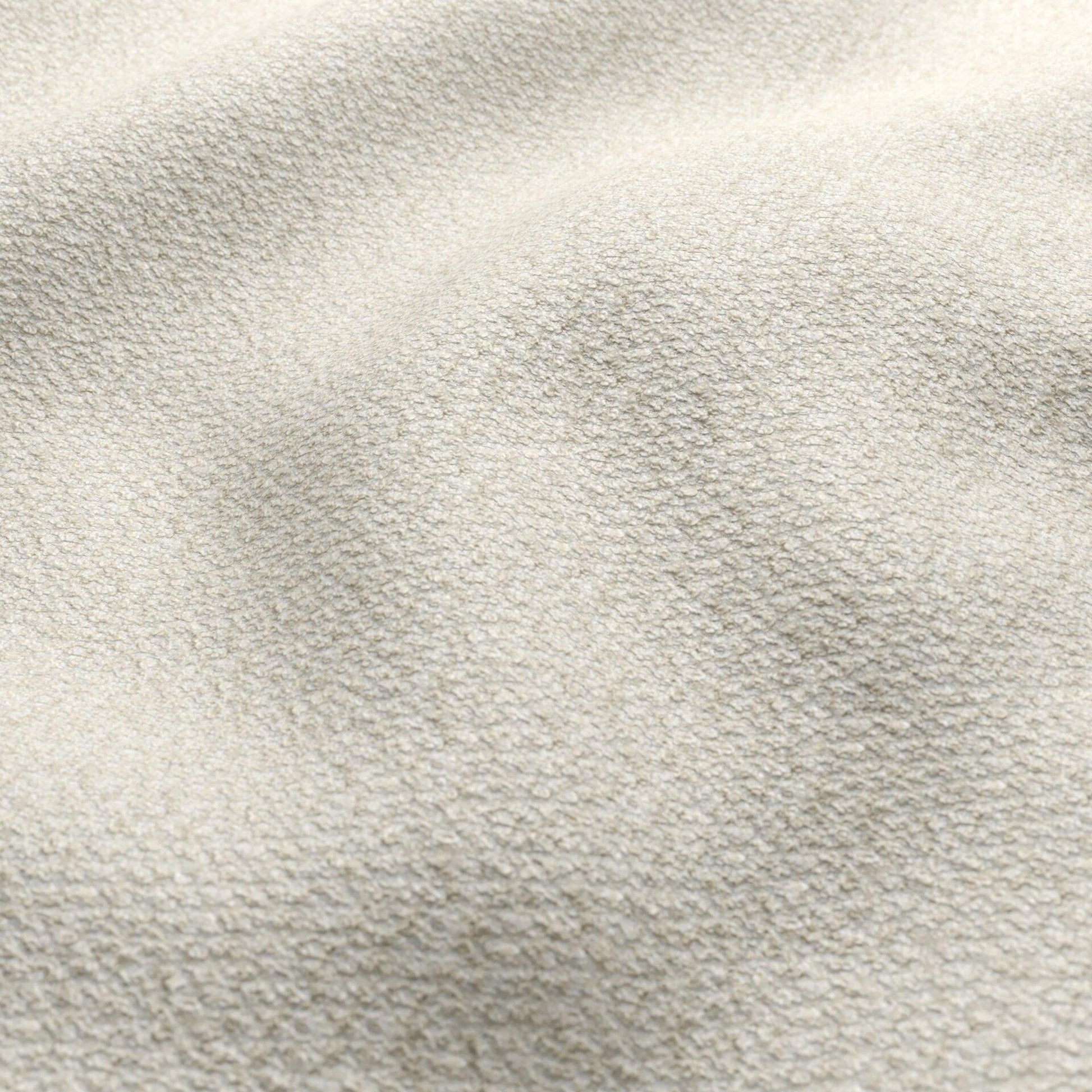 Beige boucle fabric with a textured ivory surface; close-up of textile.