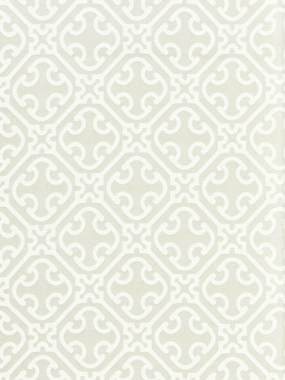 Beige wallpaper with white interlocking curved-quatrefoil pattern in a repeating lattice.