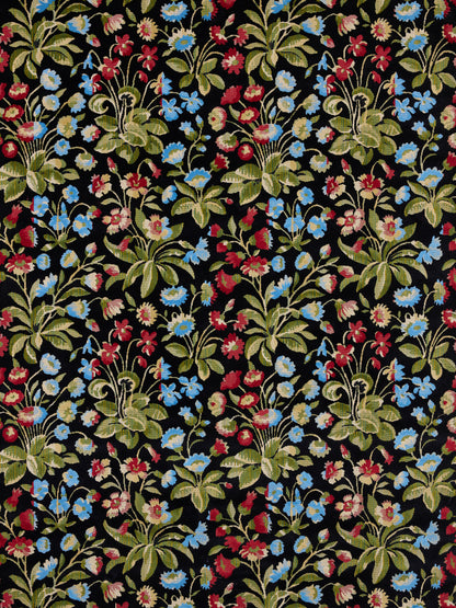 Black fabric with dense multicolor floral print in blue, red, pink flowers and green leaves, repeating botanical bouquets.