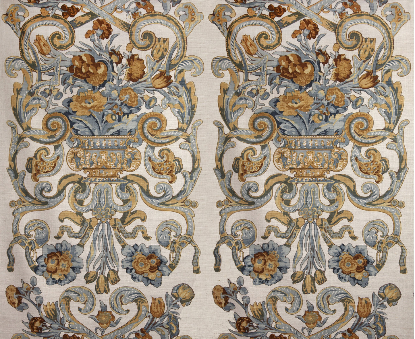 Two mirrored ornate floral damask rug panels in blue, gold and beige with urns and scrolling vines.