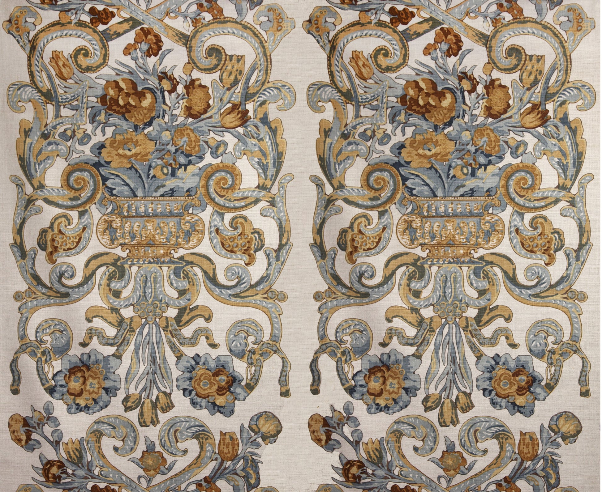 Two mirrored ornate floral damask rug panels in blue, gold and beige with urns and scrolling vines.