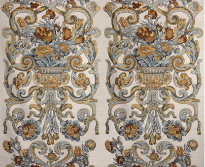 Two mirrored ornate floral damask rug panels in blue, gold and beige with urns and scrolling vines.