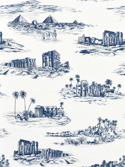 Blue and white toile pattern of ancient ruins, temples, pyramids and palm trees in a desert landscape motif.