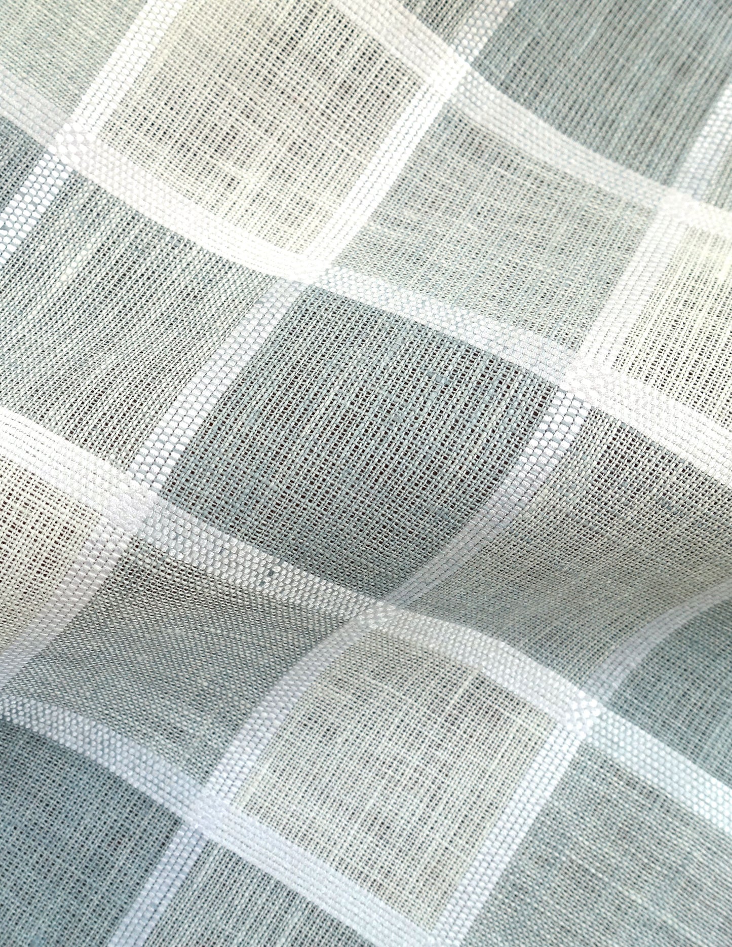Light blue and white plaid woven fabric with a grid pattern; linen-like texture for curtains or cushions.
