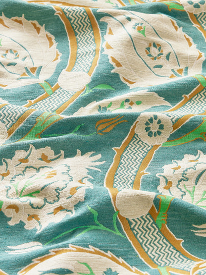Teal fabric with cream floral prints, gold borders & teal & gold zigzag stripes; tropical scarf-style textile.