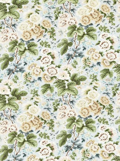 Floral linen print fabric pattern with cream and yellow roses and large green leaves on a light blue background.