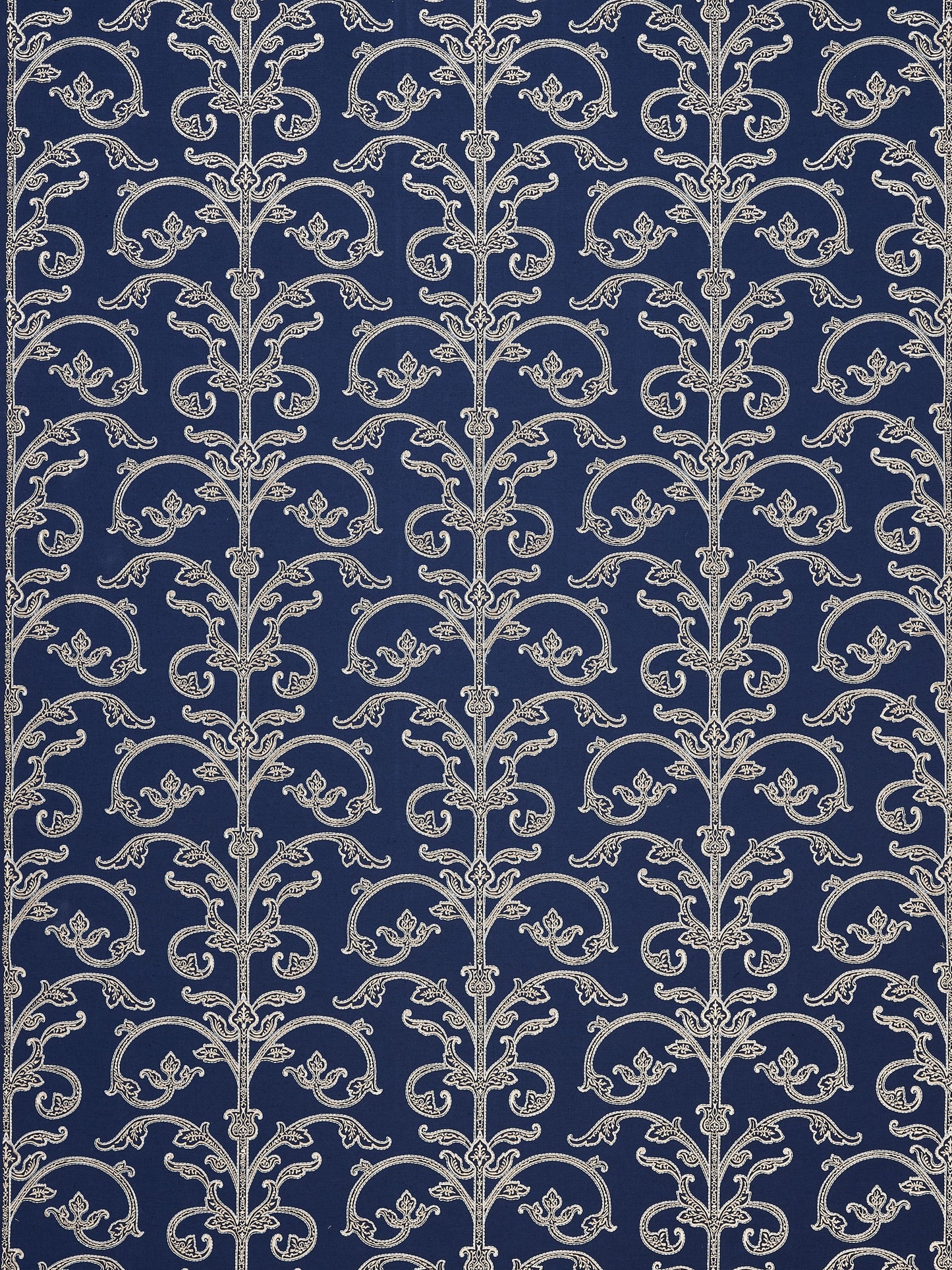 Navy wallpaper featuring repeating silver damask scrollwork vines and floral accents in a vintage pattern.