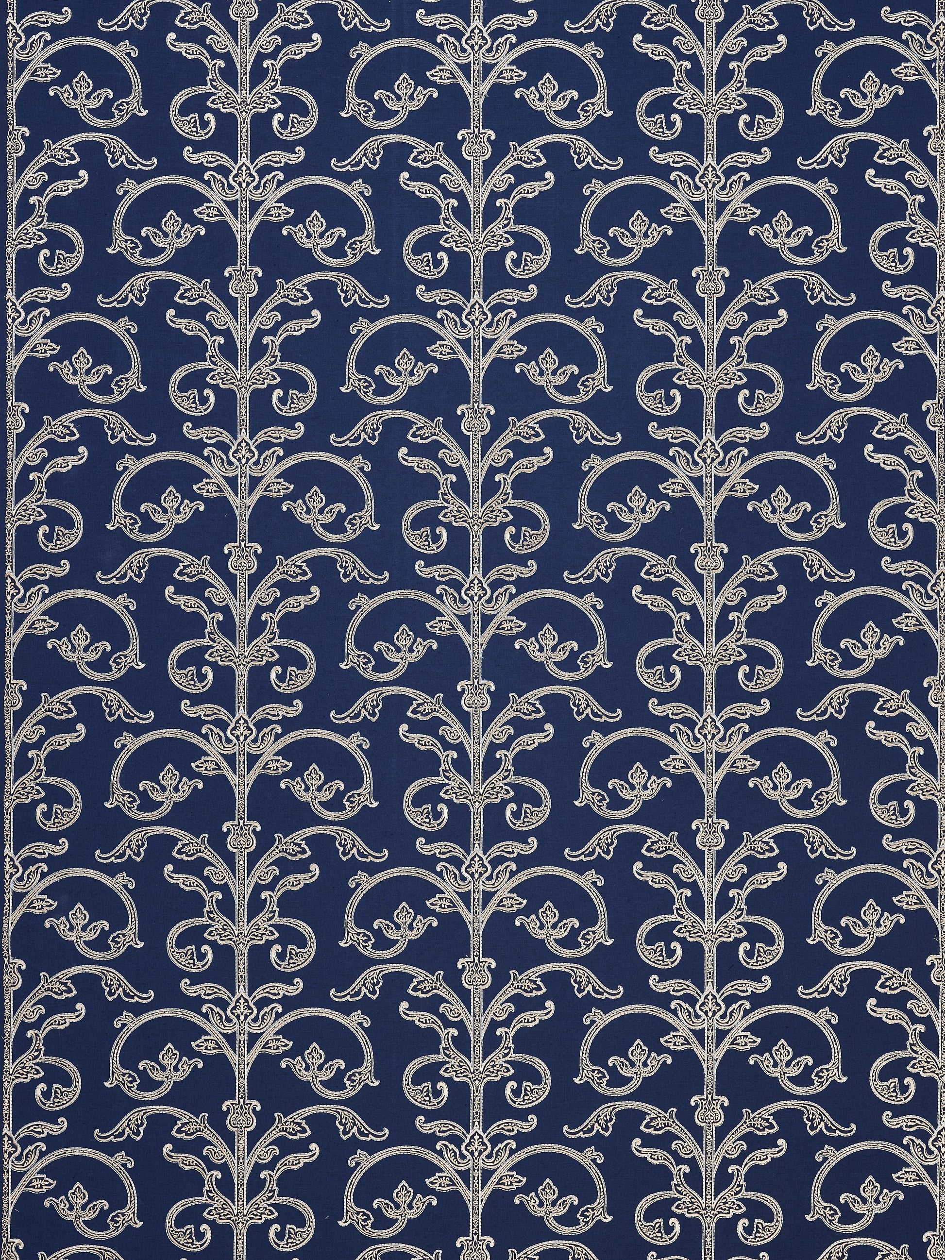 Navy wallpaper featuring repeating silver damask scrollwork vines and floral accents in a vintage pattern.