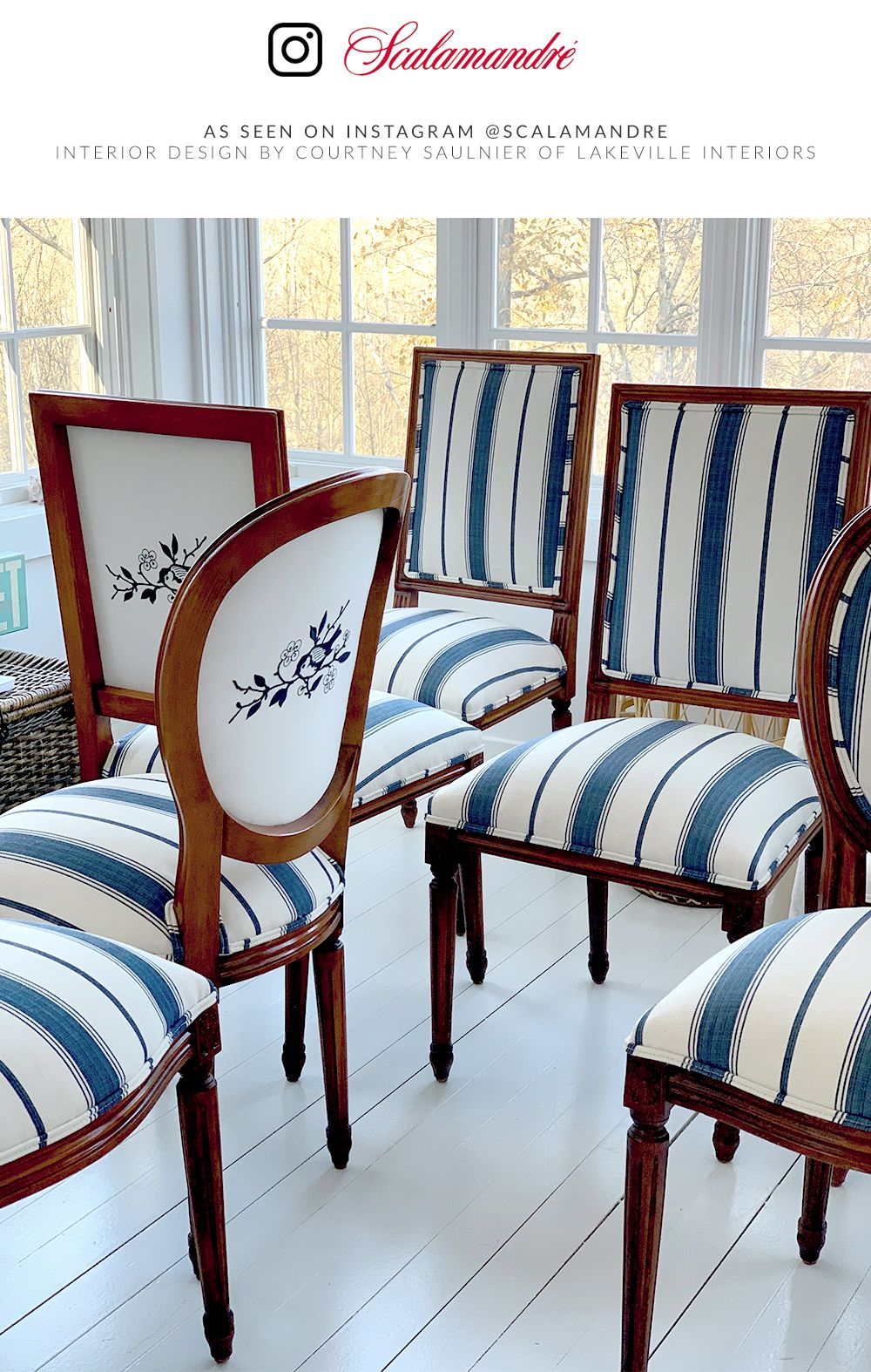 Vintage dark-wood dining chairs with blue-and-white striped upholstery; one chair features a white back panel with a floral motif.