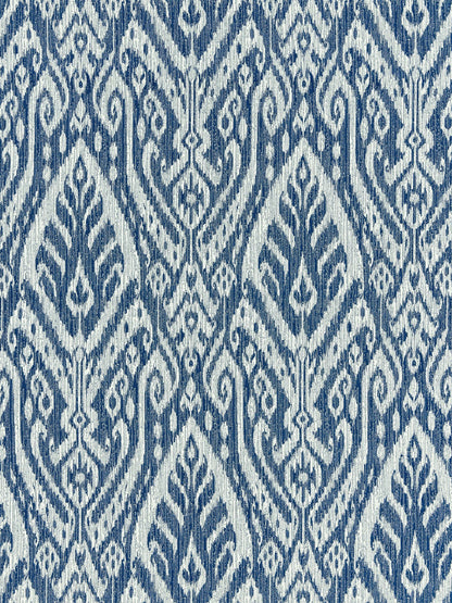 Blue and white woven textile with ikat-inspired geometric pattern, decorative fabric for upholstery or curtains.