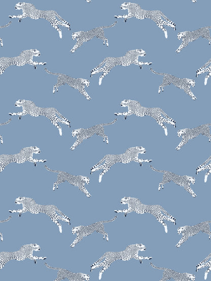 Blue fabric with repeating white cheetah silhouettes in mid-leap.