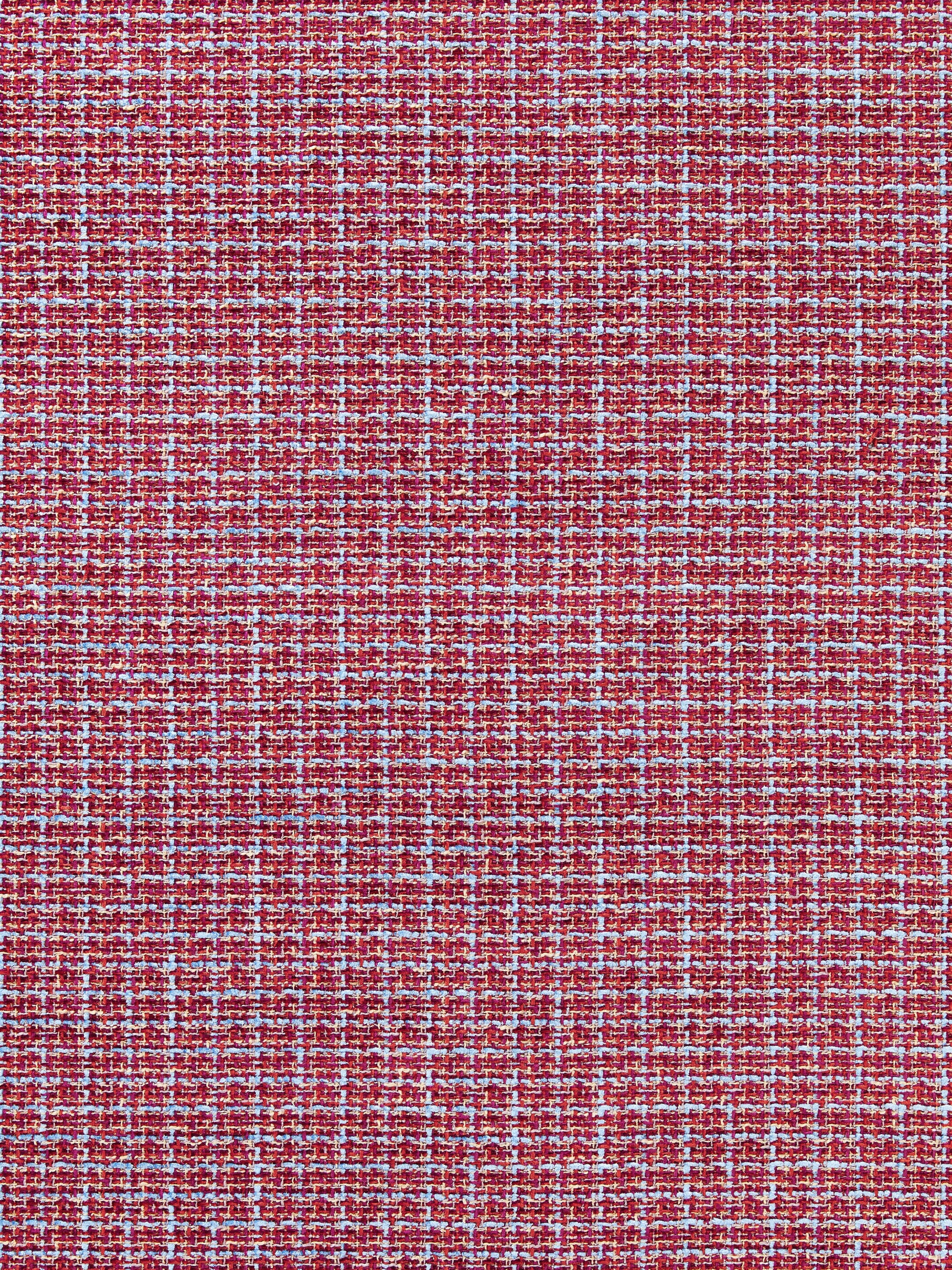 Close-up of red tweed fabric with white & blue flecks; textured woven textile.