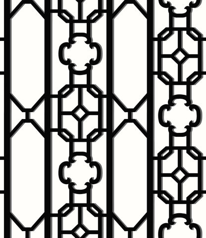 Decorative black wrought-iron fretwork lattice with vertical bars and geometric octagon and clover motifs.