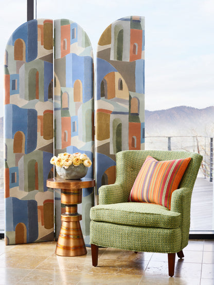 Sunset Highland Chenille fabric swatch in green with a textured weave, shown beside pastel folding screens and a wooden side table with yellow roses.