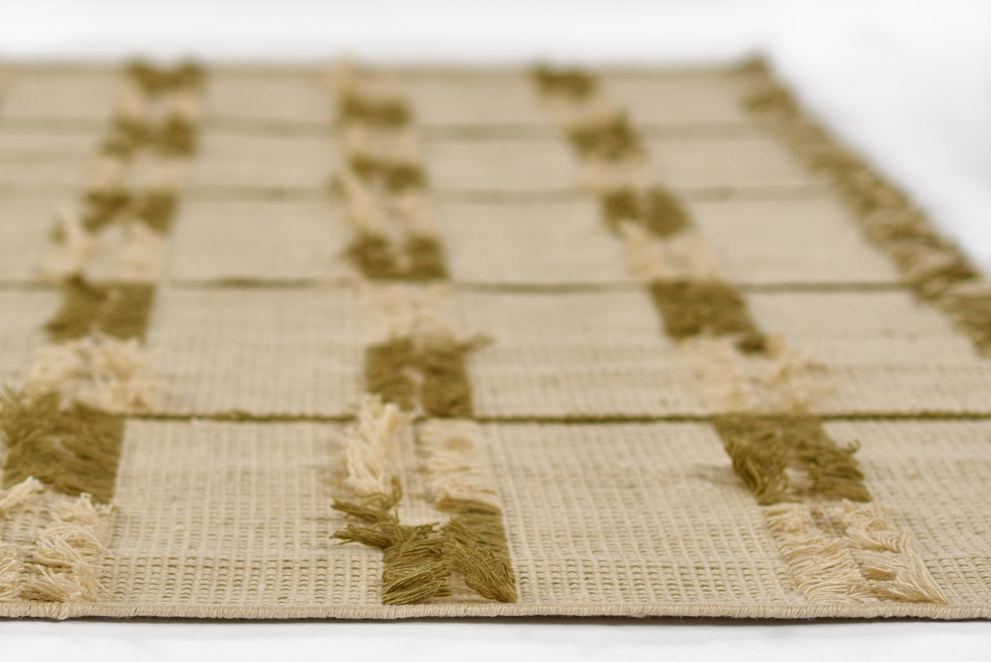 Beige textured jute rug with brown stripe blocks and fringed ends; rectangular casual rug for living room or hallway.