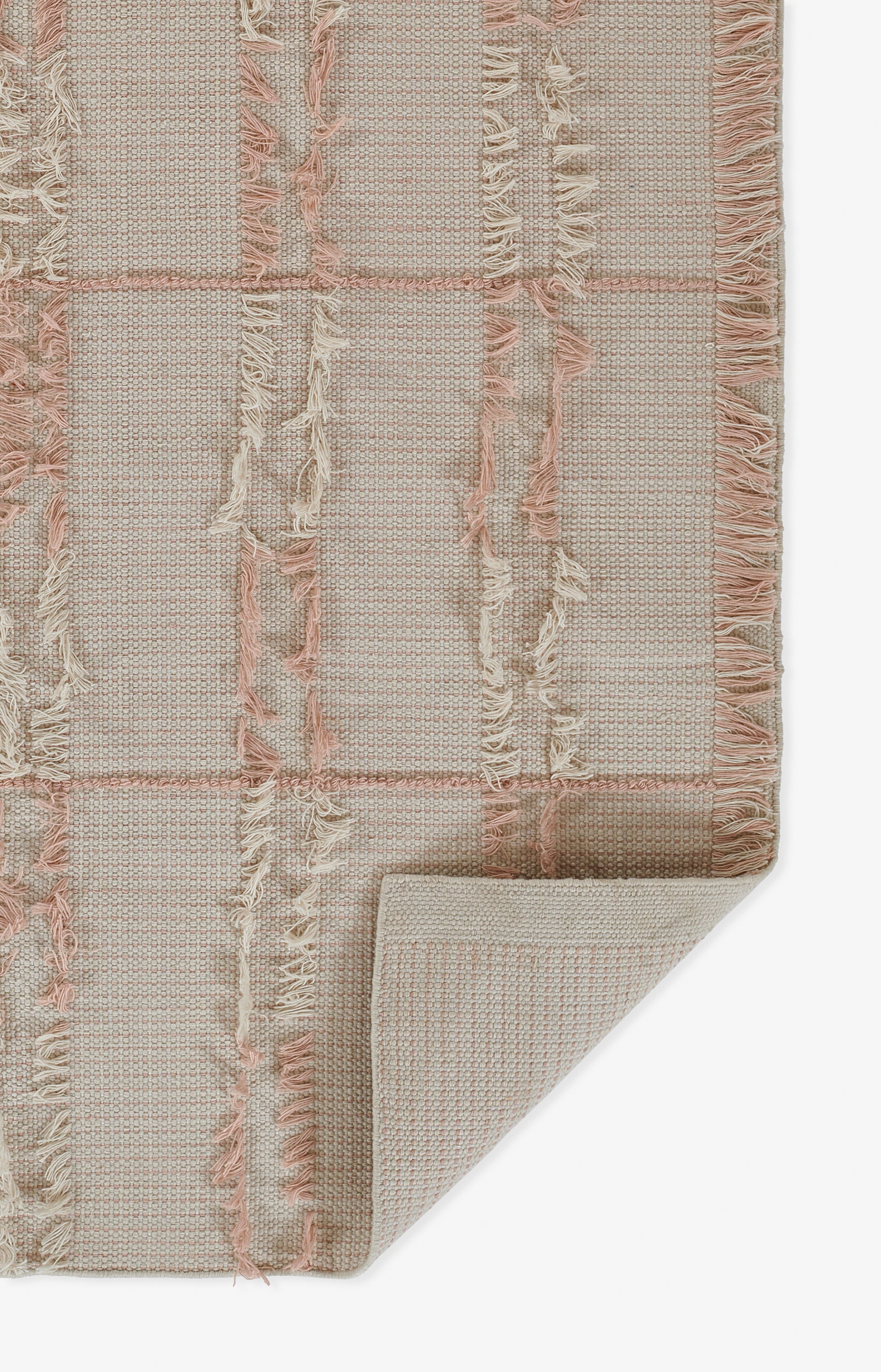 Pink-beige woven rug with checkered grid pattern & fringed edges; soft textured floor décor.