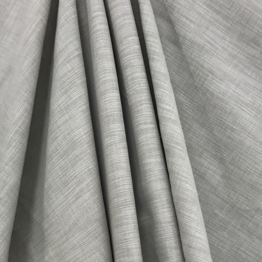 Green shantung fabric draped in folds, showcasing subtle weave and soft, elegant texture; faux silk finish.