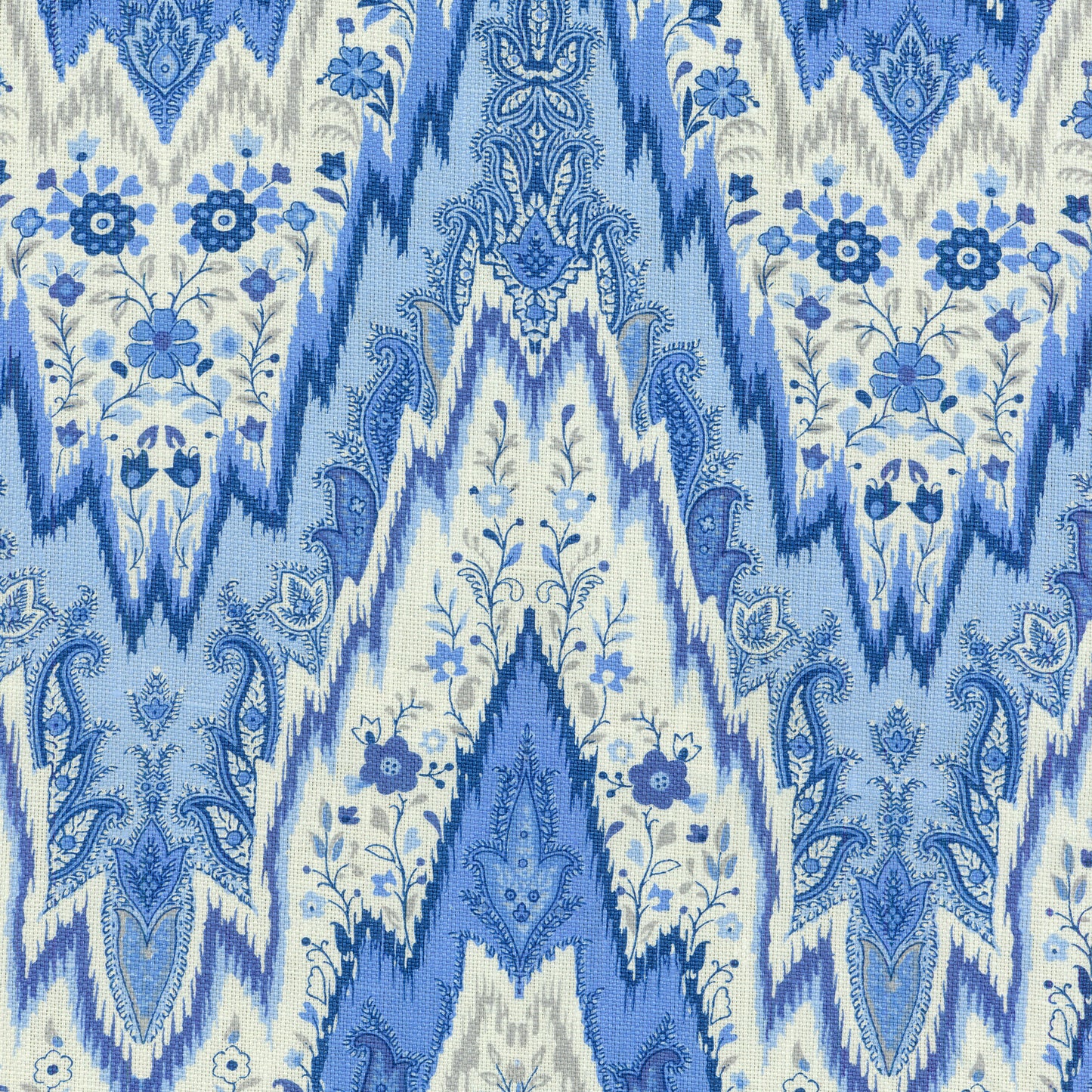 Blue and white shibori-ikat linen fabric with floral motifs for upholstery or drapes.