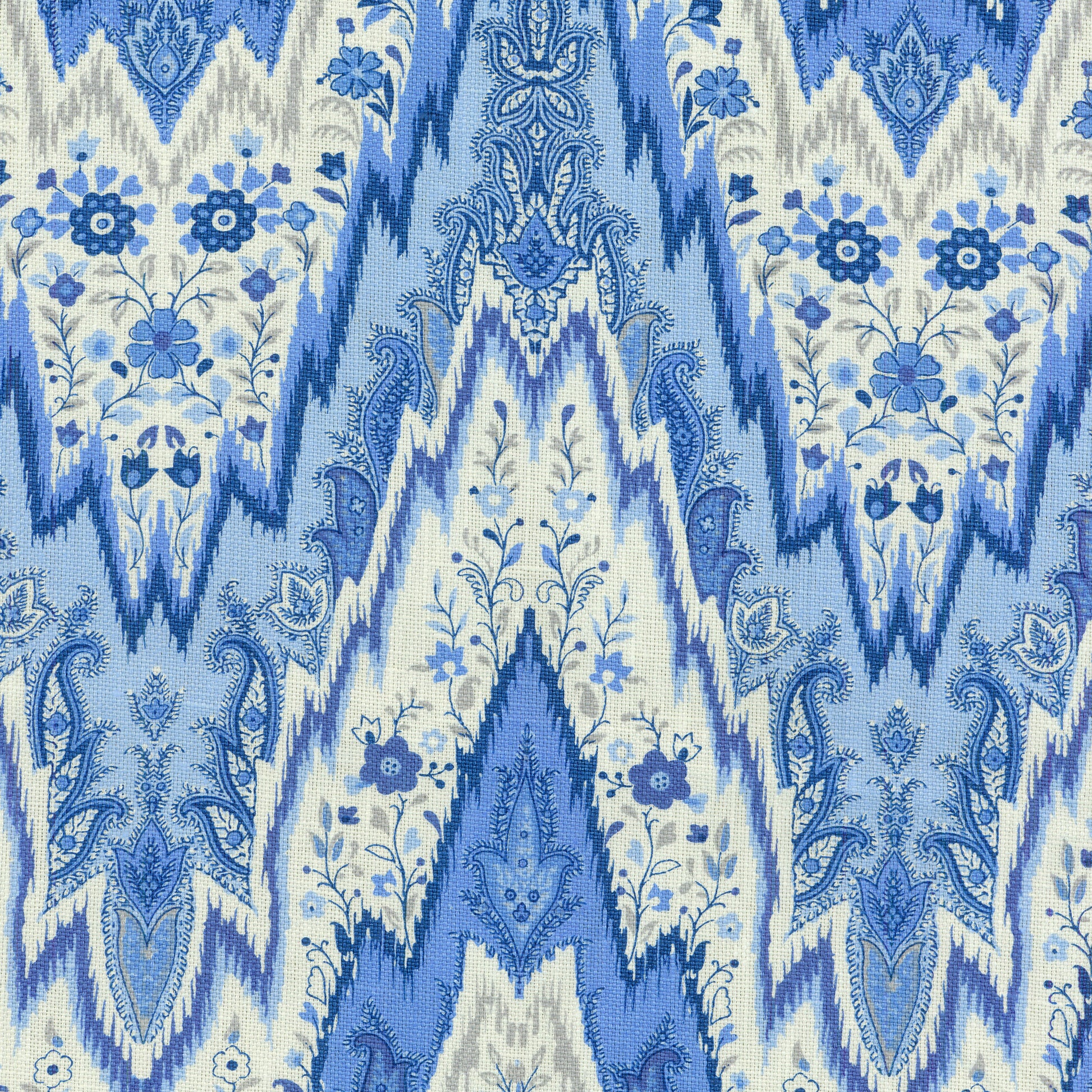 Blue and white shibori-ikat linen fabric with floral motifs for upholstery or drapes.