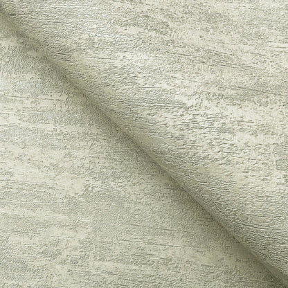 Beige weathered stucco wallpaper texture close-up with a diagonal fold.