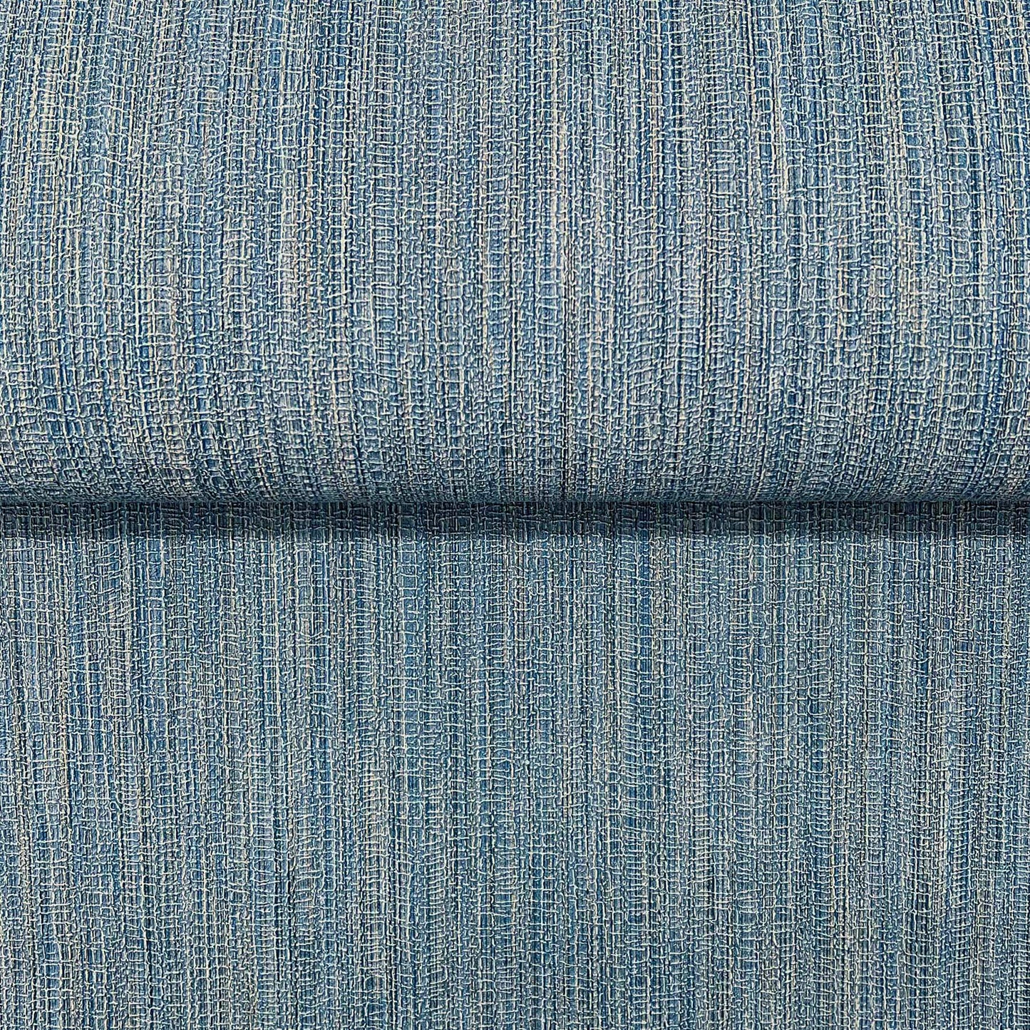 Blue denim-like woven fabric with vertical rib texture and subtle beige flecks; folded upholstery swatch.