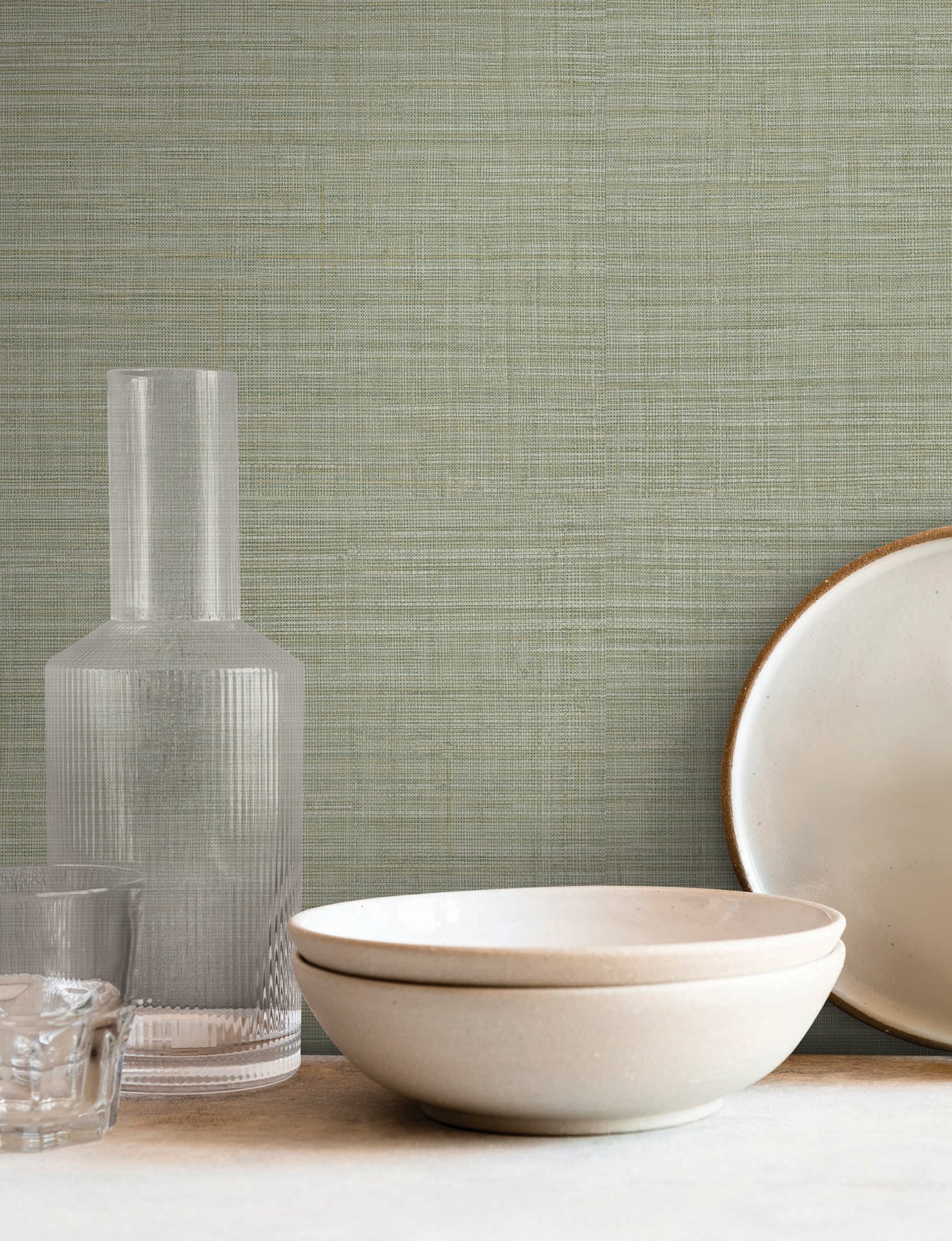 Sea-foam wallpaper with a subtle traditional weave pattern on the wall.