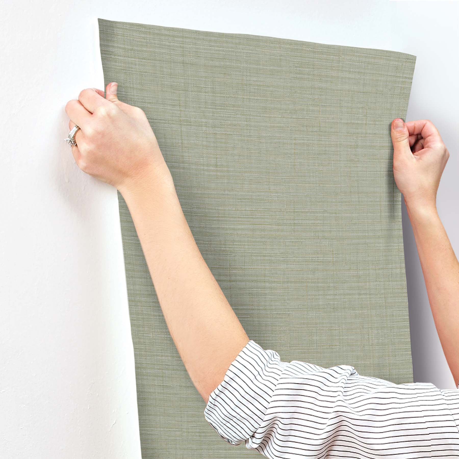 Sage green textured fabric wall panel swatch with linen-like weave, rectangular and held upright.