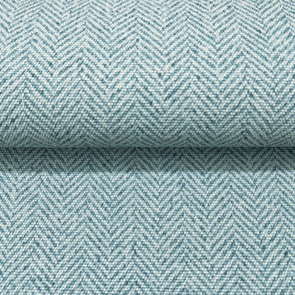 Close-up of light blue chevron wallpaper with a subtle woven texture.