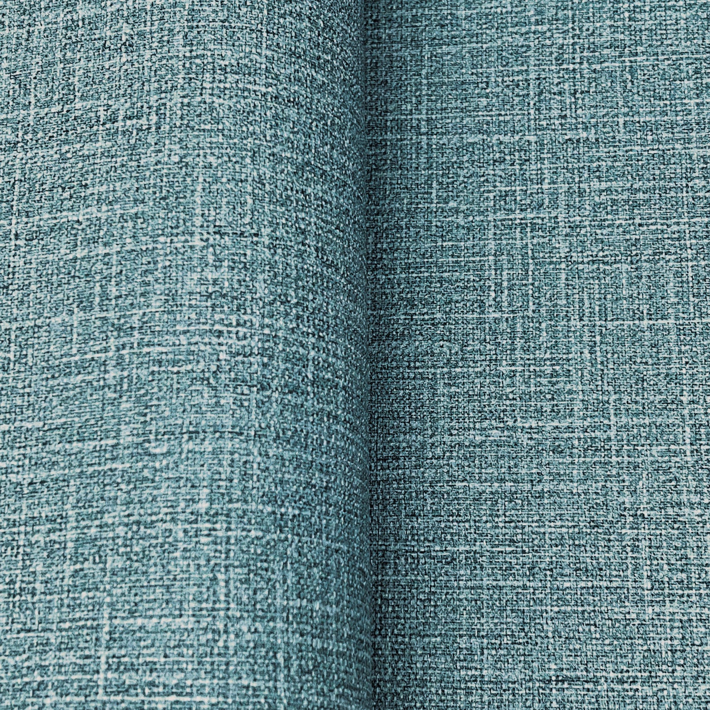 Teal woven wallpaper with a linen-like crosshatch texture; close-up detail showing a denim blues wallpaper pattern.