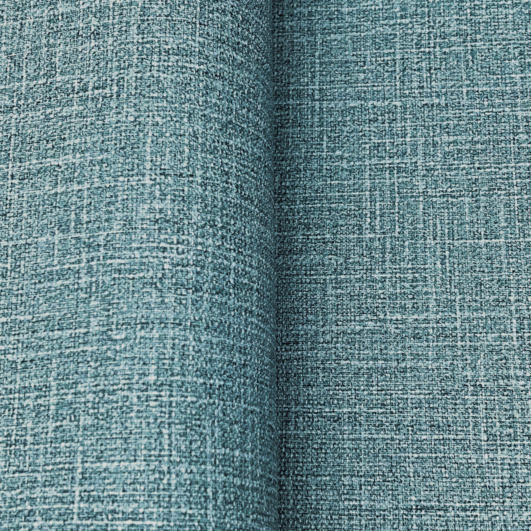 Teal woven wallpaper with a linen-like crosshatch texture; close-up detail showing a denim blues wallpaper pattern.