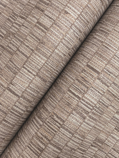 Taupe wallpaper with a grey transitional stripe pattern, rolled.