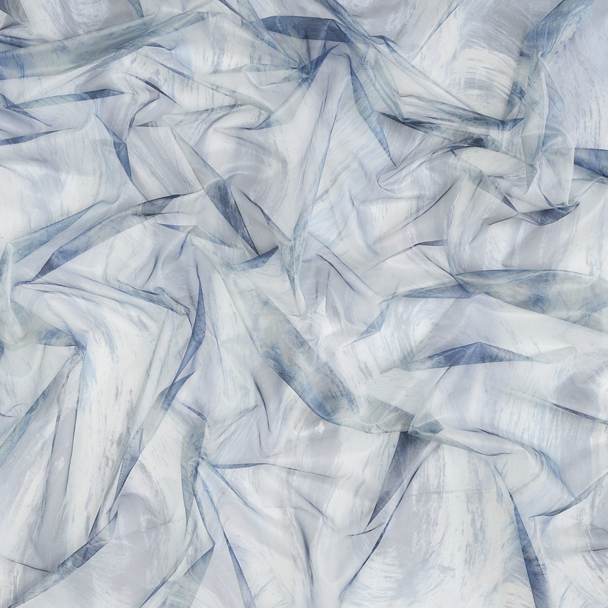 Crinkled sheer fabric swatch in abstract blue, green and teal tones with soft drape.