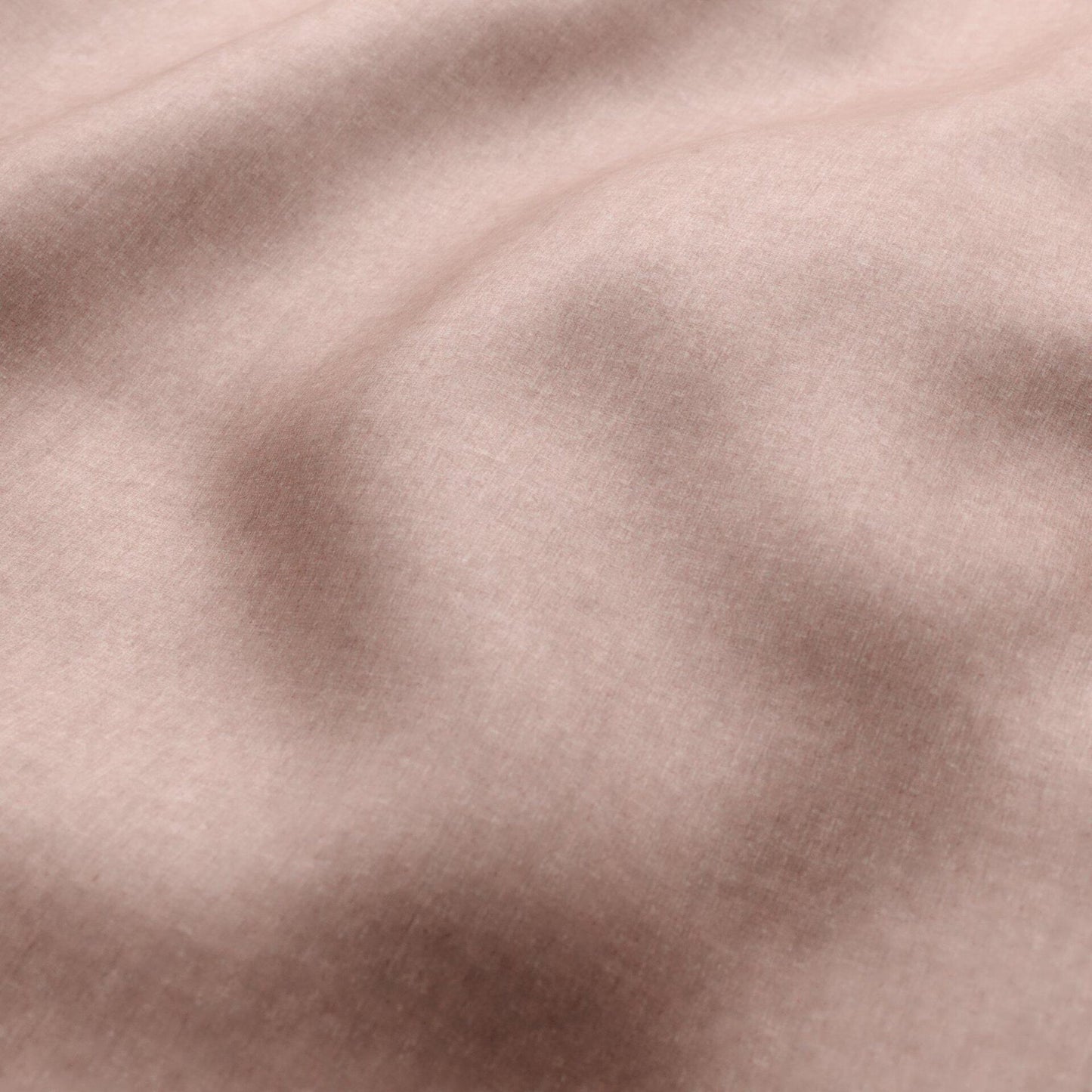 Soft pink velvet fabric close-up with visible nap, gentle folds and subtle sheen.