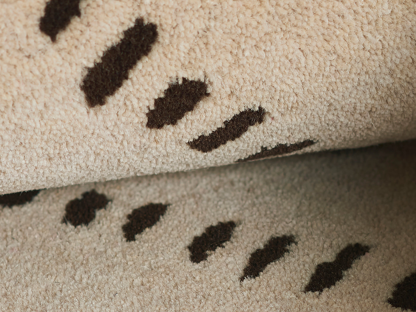 Beige shag rug with dark brown abstract dash pattern; soft, plush, modern floor decor.