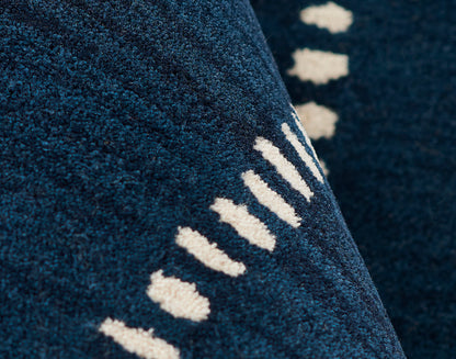 Close-up of navy blue plush runner with a cream linear dash pattern (3' x 8').