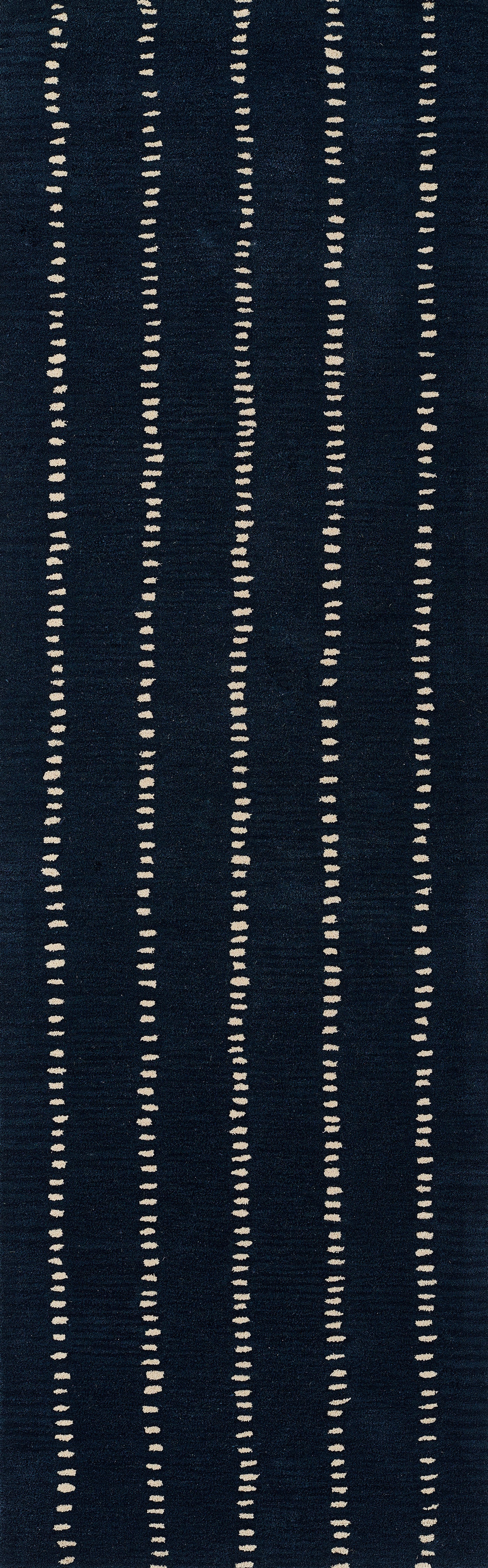 Navy blue area rug with evenly spaced vertical cream dotted lines in a modern geometric pattern.