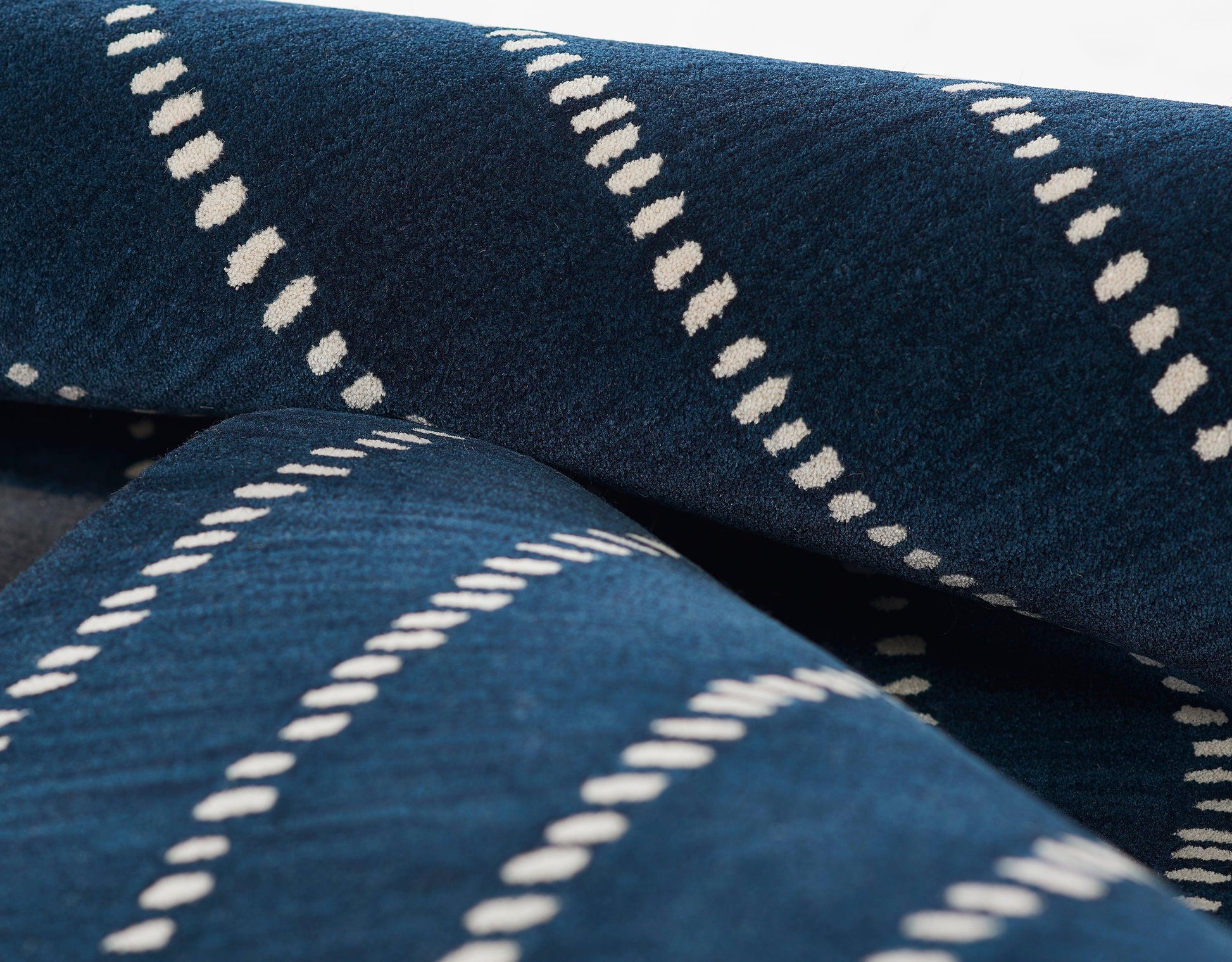 Navy blue rug runner with white diagonal dashed stripes; plush textile; 3' x 8'.