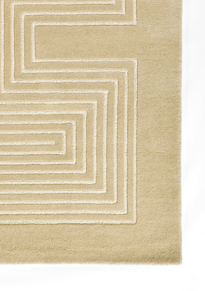 Beige rug with cream raised geometric spirals; modern abstract design with soft plush pile.