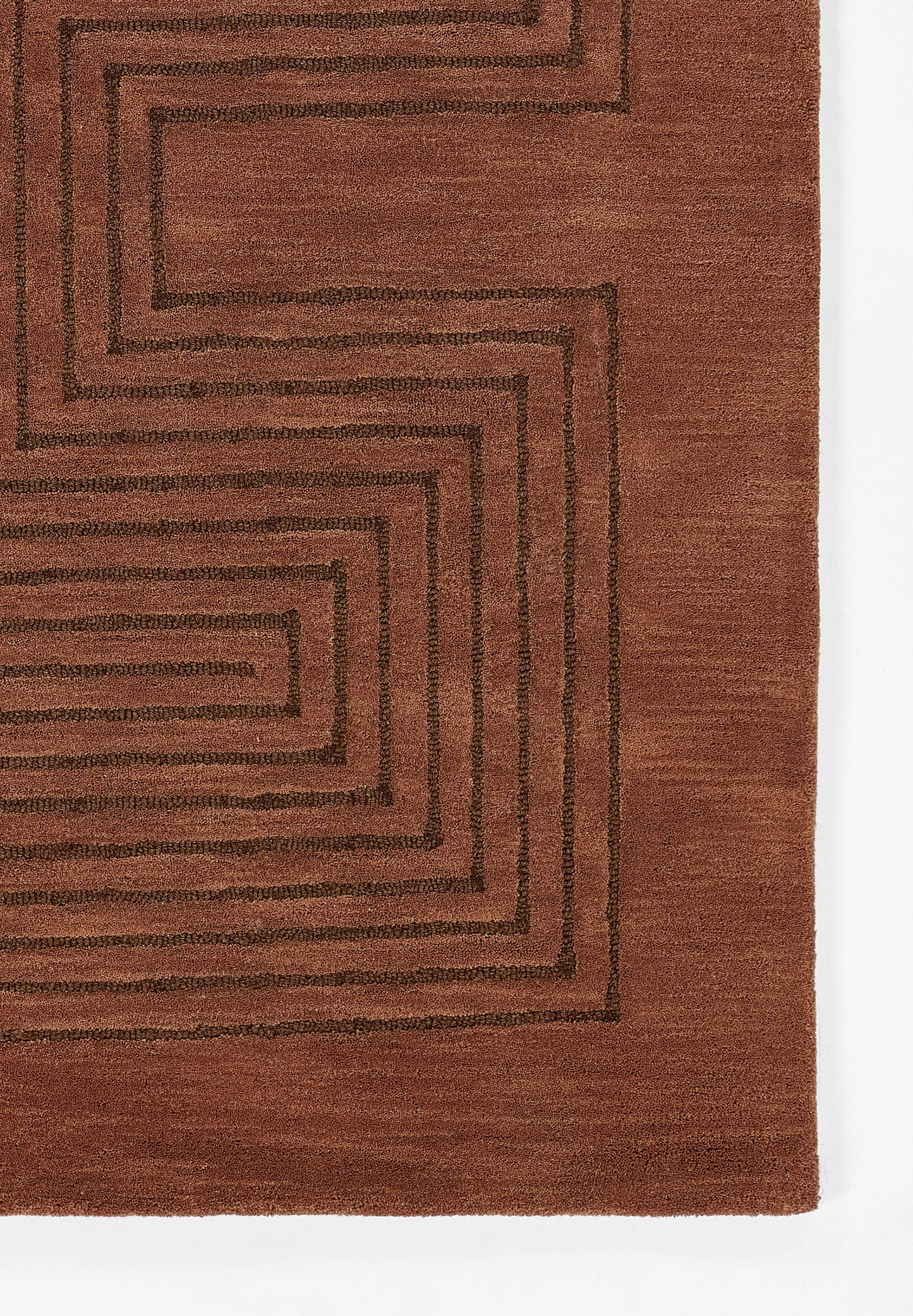 Rust-orange woven rug with dark brown concentric square maze pattern; rectangular, modern geometric style.