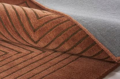 Rust-colored rug runner with a dark stripe pattern, 2'6" x 8'.